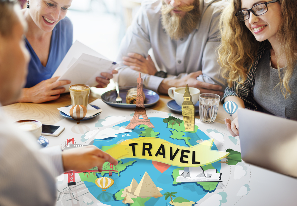 A group of people discussing travel opportunities for college grads at a coffee shop