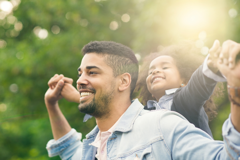 A girl and her father play on Father's Day
