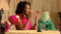 Michelle Obama dancing with Elmo on Sesame Sheet.