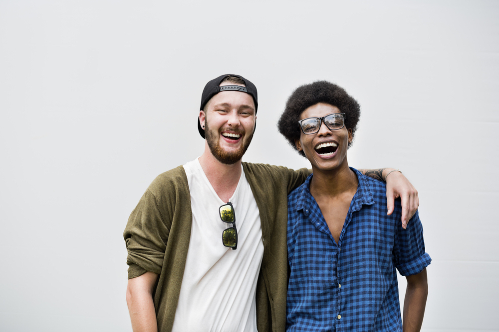 Two students smile after successfully starting a club in college.