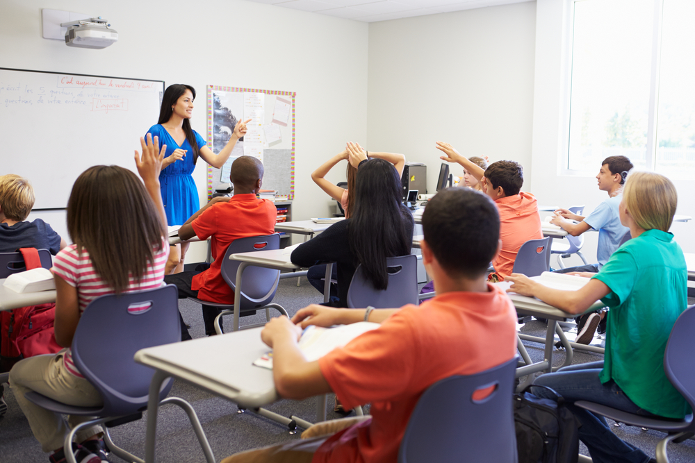 A classroom of juniors college planning with the help of their teacher.